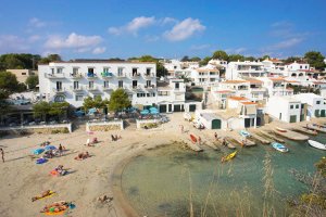 Zona de arena de la playa de Cala Alcaufar con bañistas durante un día de verano no-movil